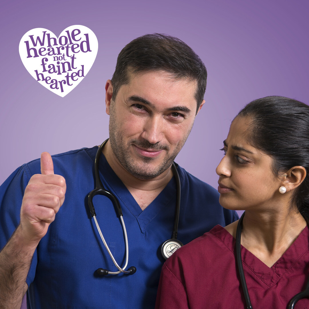 Two Trust Medical staff with campaign graphic