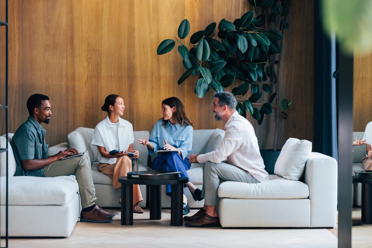 A group gathered on couches, looking comfortable and at ease.